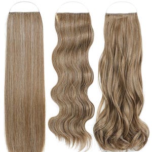 May include: Three hair extensions with a halo-style wire attachment. The first is straight, light brown with blonde highlights. The second is wavy, medium brown. The third is deeply curled, light brown with subtle blonde highlights throughout.