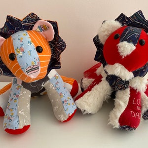 May include: Two handmade patchwork lion plushies. One is orange and blue with a rainbow and ice cream cone on its chest. The other is red with white fur and a blue and white paisley pattern. The red lion has the text "Love my Dad" embroidered on its leg.