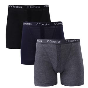 May include: Three pairs of boxer shorts in black, navy blue, and grey. Each pair has a button fly and the words "C Classics" printed on the waistband.