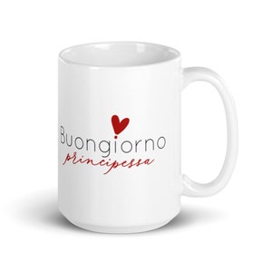 May include: White ceramic coffee mug with a black and white graphic that says "Buongiorno principessa" with a red heart above the text.