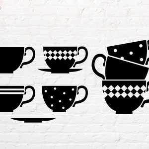 May include: A set of five black teacups with different patterns. The teacups are on a white brick background. The teacups have a checkered pattern, a polka dot pattern, and a solid black design.