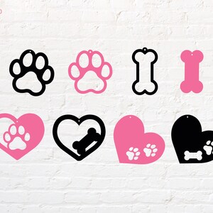 May include: Nine different dog-themed shapes for crafting, including paw prints, bones, and hearts. The shapes are in black and pink.