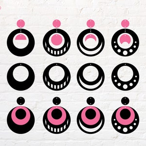 May include: Nine pairs of earrings with different geometric designs. Each earring is a black circle with a pink circle inside. The designs include a crescent moon, a circle with dots, a circle with stripes, and a circle with a half circle.