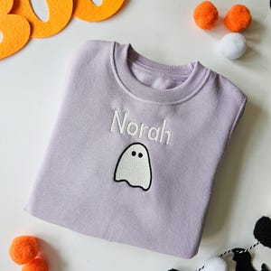 Lilac crew neck sweatshirt, embroidered with glow in the dark ghost personalised with childs name. Machine embroidered in the UK