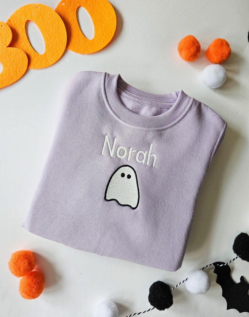 Lilac crew neck sweatshirt, embroidered with glow in the dark ghost personalised with childs name. Machine embroidered in the UK