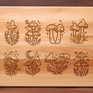 May include: A wooden cutting board with eight different engraved designs of mushrooms. Each design features a cluster of mushrooms with a crescent moon and stars.