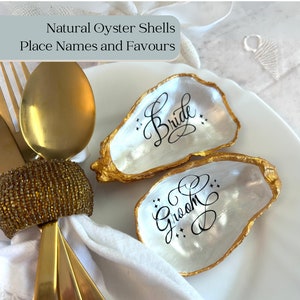 Gold oyster shell wedding place card and favour. Personalised name place for beach themed wedding. Wedding keepsake name card ring holder.