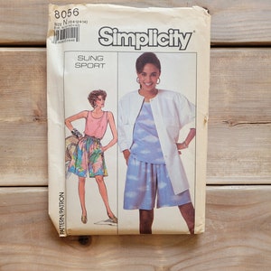May include: Simplicity sewing pattern number 8056 for a sung sport outfit. The pattern includes instructions for making a white shirt with a blue and white cloud print and a pair of blue shorts.