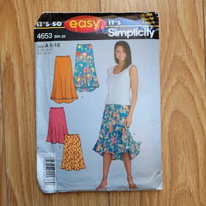 May include: A sewing pattern for a skirt with three different styles. The pattern is from Simplicity and is for sizes 6-16. The skirt is shown in three different colours: orange, pink, and blue.