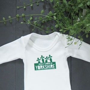 Locally grown baby outfit personalised with new baby’s own birth town, county or country. 

A custom baby onesie perfect for a homegrown newborn baby boy or baby girl.