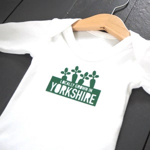 Locally grown baby outfit personalised with new baby’s own birth town, county or country. 

A custom baby onesie perfect for a homegrown newborn baby boy or baby girl.