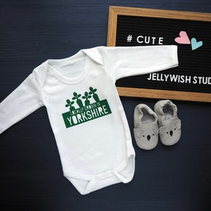 Locally grown baby outfit personalised with new baby’s own birth town, county or country. 

A custom baby onesie perfect for a homegrown newborn baby boy or baby girl.