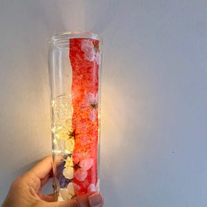 Repurposed glass: Recycled Votive candle holders decorated with pressed flowers and grains. Surprise a friend with this unique gift.