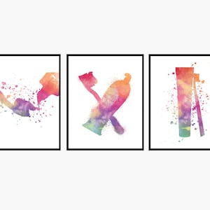 May include: Set of three watercolor prints featuring bathroom essentials. The first print shows a splash of color, the second print shows a toothbrush and toothpaste, and the third print shows a razor and shaving cream.