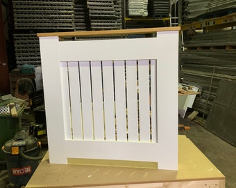 Radiator cover with vertical slats and a waxed pine top