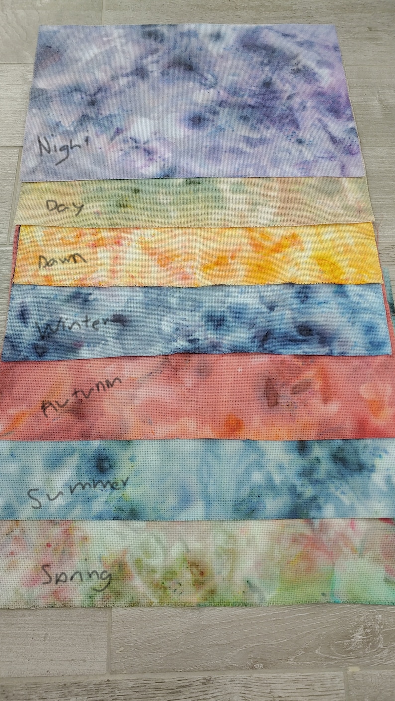 May include: Eight fabric swatches with tie-dye patterns in various colors, labeled with the words "Night", "Day", "Dawn", "Winter", "Autumn", "Summer", "Spring".