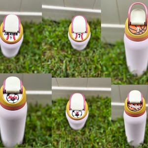 May include: A collection of personalized water bottles with sports-themed designs. Each bottle features a different sport, including baseball, basketball, and soccer, and a name and number. The bottles are pink with a yellow and white lid.