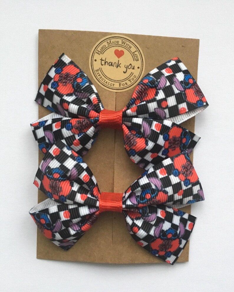 Red Nose Day patterned hair bows for toddlers, handmade with premium grosgrain ribbon and secure alligator clips or elastics.