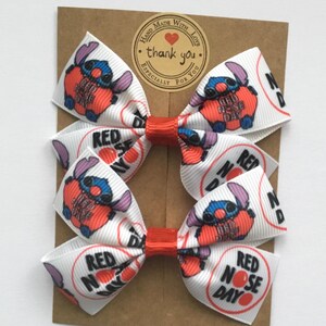 Red Nose Day patterned hair bows for toddlers, handmade with premium grosgrain ribbon and secure alligator clips or elastics.