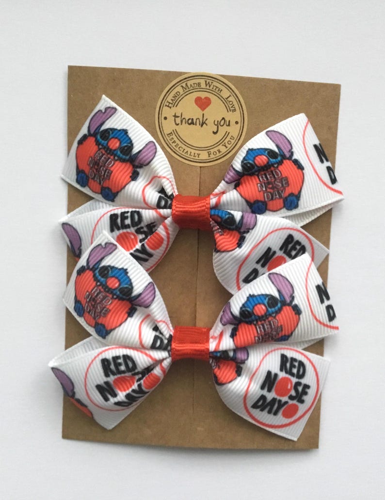 Red Nose Day patterned hair bows for toddlers, handmade with premium grosgrain ribbon and secure alligator clips or elastics.