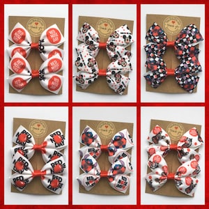 Collection of 6 different Red Nose Day hair bow designs for girls. Handmade red and white bows on display cards, perfect for school charity events in the UK.