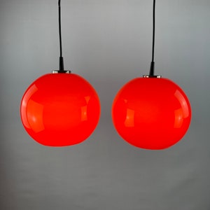 Pair of two cherry red glass Peill & Putzler pendant lights