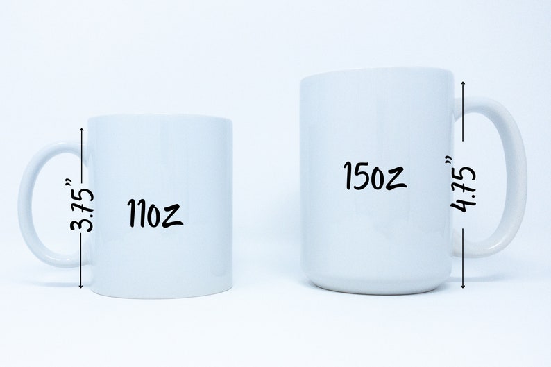 May include: Two white ceramic mugs with black handwritten text. The smaller mug is 11 oz and 3.75 inches tall. The larger mug is 15 oz and 4.75 inches tall.