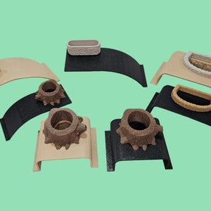 May include: Six different decorative planters, each with a unique design. The planters are made of a textured material and are displayed on a variety of bases, including wood and black plastic.