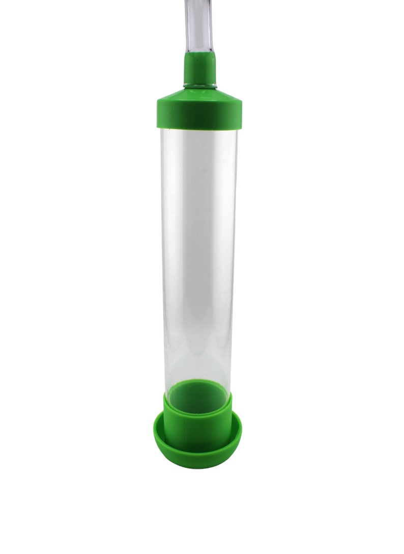 Peut inclure: Un tube en plastique transparent avec un dessus et une base verts. Le tube est con&ccedil;u pour nourrir les oiseaux et a un bec verseur en haut.