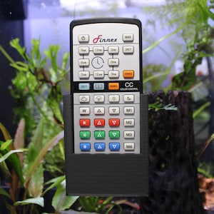 May include: A black Finnex remote control with a digital clock display and buttons for setting time, color, and intensity. The remote is mounted on a black wall mount.