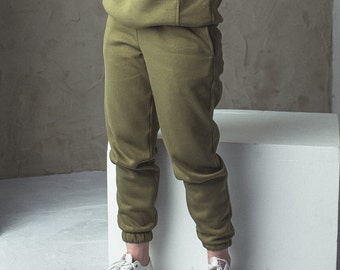 Green jogging pants. Cuffed ladies joggers with pockets and elastic waist. Warm thick cotton jersey sweatpants. Comfy tracksuit bottoms.