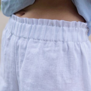 Classic white linen shorts for women. Minimalis shorts with pockets. Elastic waist shorts low rise. Stylish Loose linen shorts for summer. image 4