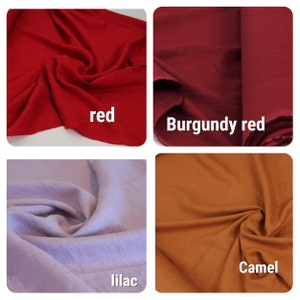 May include: Four fabric swatches in different colors: red, burgundy red, lilac, and camel. The swatches are folded and arranged in a grid.