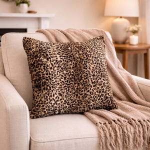 May include: A set of three ceramic mugs with a speckled, matte finish. The mugs are in shades of cream, light gray, and dark gray. Each mug has a simple, minimalist design and a rounded handle. The mugs are likely for coffee or tea.