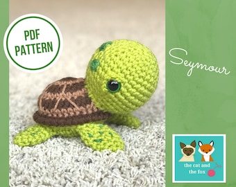 May include: A crocheted green turtle amigurumi toy named Seymour. The turtle has brown shell details and green eyes. The image includes the text "PDF PATTERN" and "Seymour".