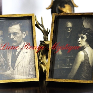May include: Two framed vintage-style prints with gold frames. One features a man in a lab coat holding a glass jar with a creature inside, the other a woman and a monster. The text "Lune Rouge Mystique" is visible.