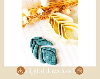 May include: A teal leaf-shaped cookie cutter made of plastic and a matching teal textured leaf-shaped cookie. The cookie cutter has a hollow frame with internal dividers to create leaf veins. The text digital download is visible.