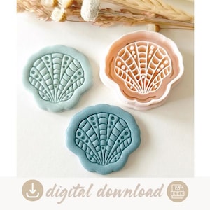 May include: Three seashell-shaped cookie cutters and stamps. One is a light peach plastic cutter, while the other two are pressed clay shapes in sage green and dusty blue, each featuring a detailed radial ribbed pattern with small circular accents.