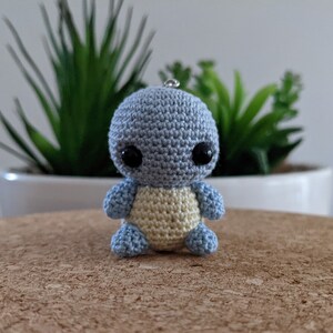 May include: A small crocheted blue and yellow turtle with black eyes.