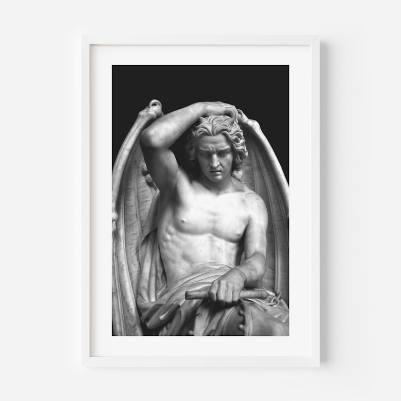 May include: Black and white photograph of a sculpture of a winged figure with a sorrowful expression. The figure is seated and has its head resting on its hand. The sculpture is made of marble and is set against a black background.