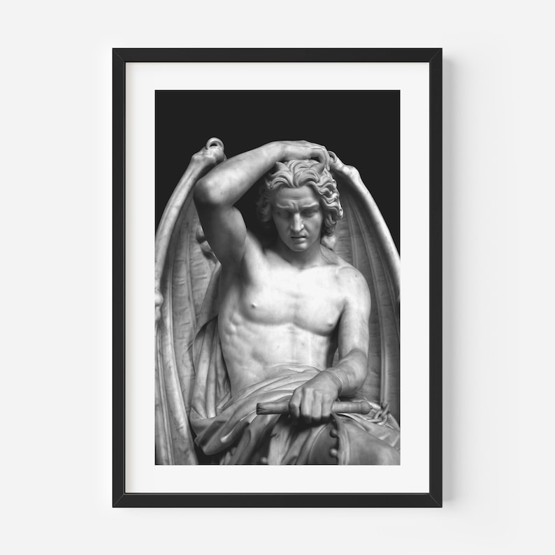 May include: Black and white photograph of a sculpture of a winged figure with a sorrowful expression. The figure is seated and has its hand on its head. The sculpture is set against a dark background.