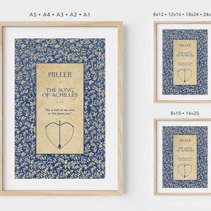 May include: A framed print of the book cover for "The Song of Achilles" by Madeline Miller. The cover features a blue and gold floral pattern with a quote from the book and a drawing of an arrow and heart.