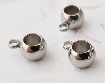 May include: Three silver metal bead caps with a small loop on top. The bead caps are round and have a smooth, shiny finish.