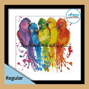 May include: A framed cross-stitch artwork featuring six colorful birds perched on a wire. The birds are depicted in shades of purple, blue, green, yellow, and red, with watercolor-style details and paint splatters. The artwork is labeled "Regular".
