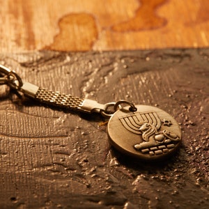 The 4 symbols of Jerusalem on a keychain. Inset with soil from Gethsemani, Mount of Olives,  Jerusalem. Original & authentic. Support Israel