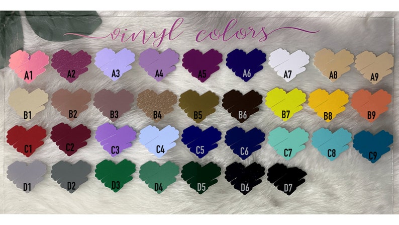 May include: A chart of vinyl colors with the text "vinyl colors" at the top. The colors are arranged in rows and columns, with each color represented by a heart shape. The colors include pink, purple, red, green, blue, yellow, orange, brown, and white.
