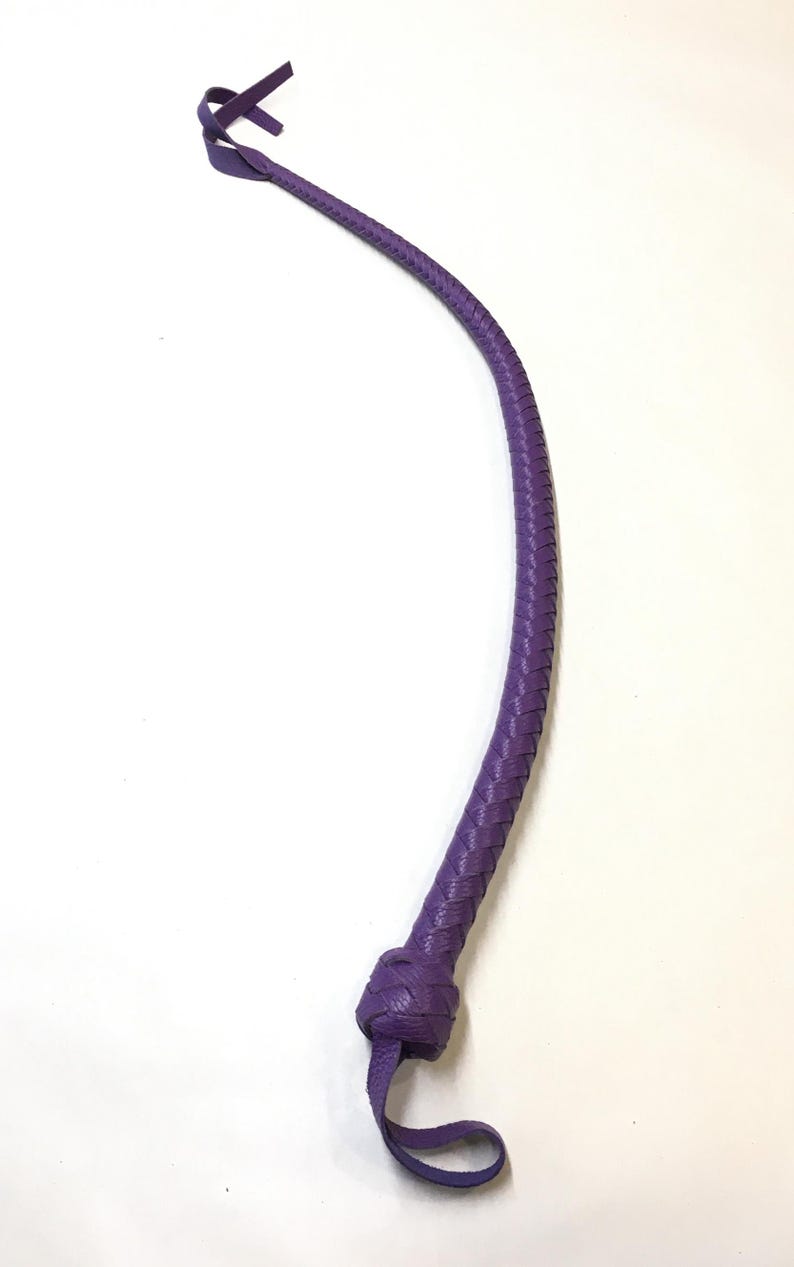 May include: A purple leather whip with a braided design and a knotted handle.