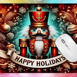 May include: A festive Christmas-themed mousepad featuring a detailed illustration of a nutcracker soldier in a red uniform and hat. The design includes holiday ornaments, snowflakes, and the text "HAPPY HOLIDAYS" on a banner. A white computer mouse is on the right.