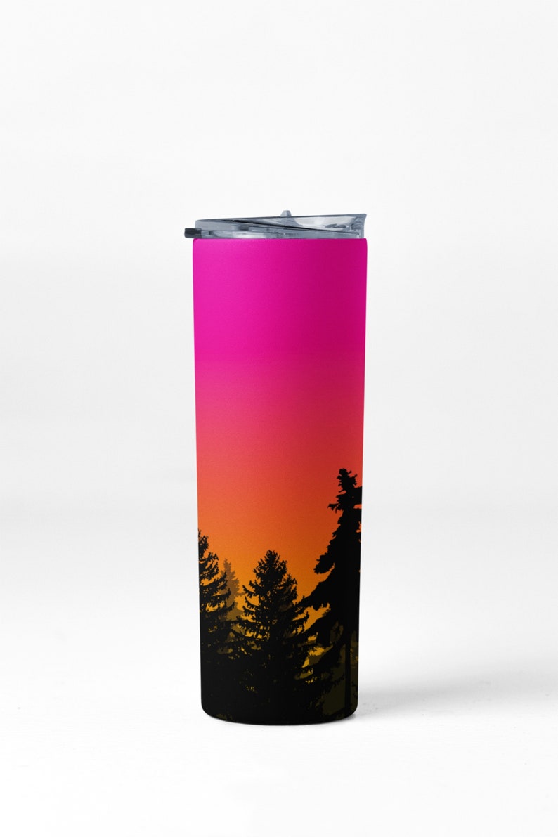 May include: A pink, orange, and yellow gradient stainless steel tumbler with a black silhouette of a forest at sunset.