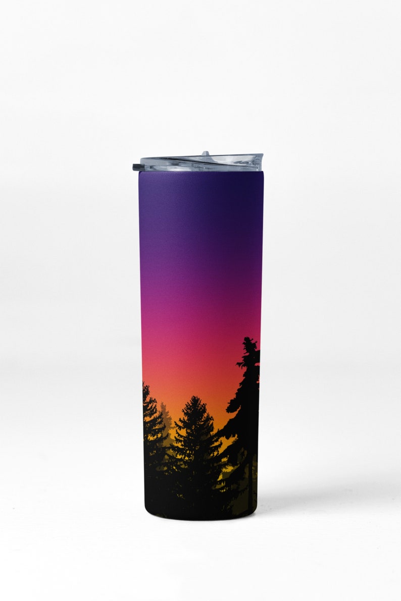 May include: A stainless steel tumbler with a purple to orange gradient design featuring a silhouette of a forest at sunset.